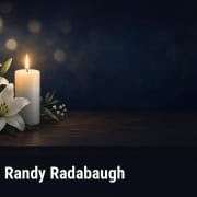 Fostoria News Memorial candle and lilies for Randy Radabaugh obituary on Fostoria Free Press.